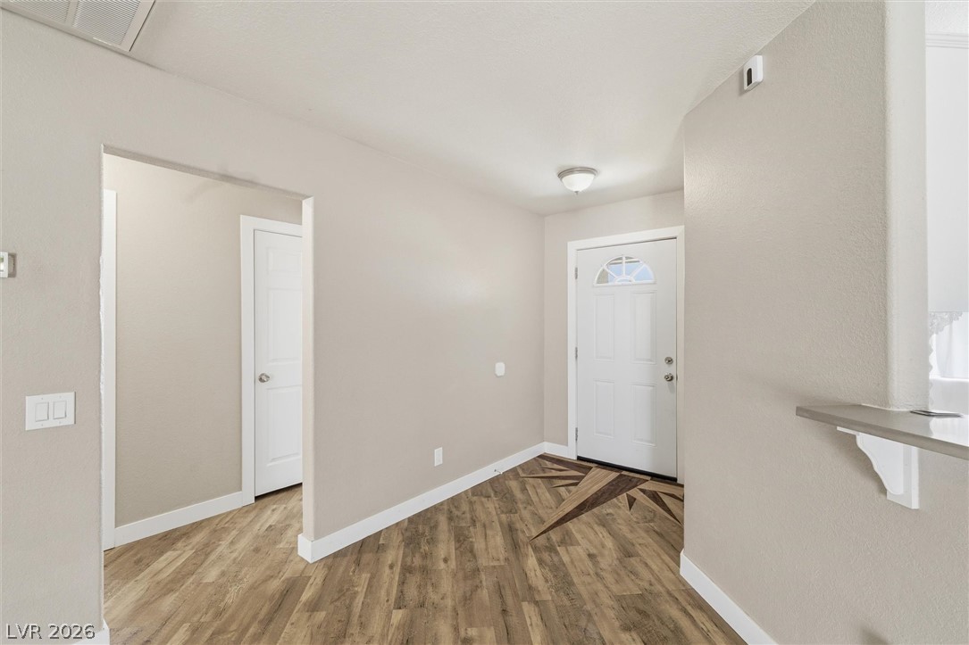2780 West Simkins Road Pahrump, NV 89060 - Photo 7 of 40 A welcoming entry features durable laminate flooring and a bright front door with an arched window.