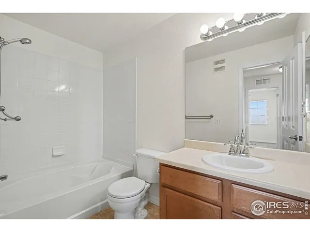 a bathroom with a sink toilet a mirror and shower