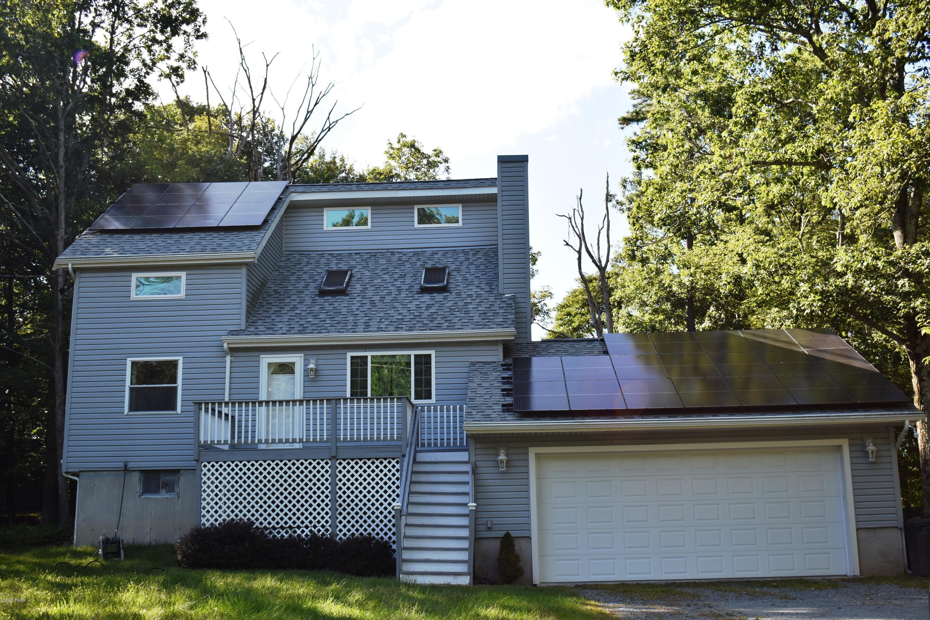 255 High Ridge Road Dingmans Ferry, PA 18328 - Photo 1 of 20 a front view of a house with a garden