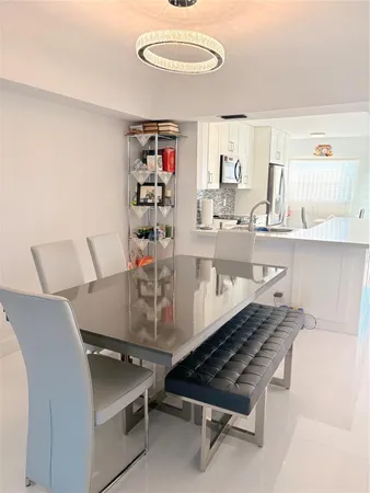 a room with stainless steel appliances furniture and a kitchen view
