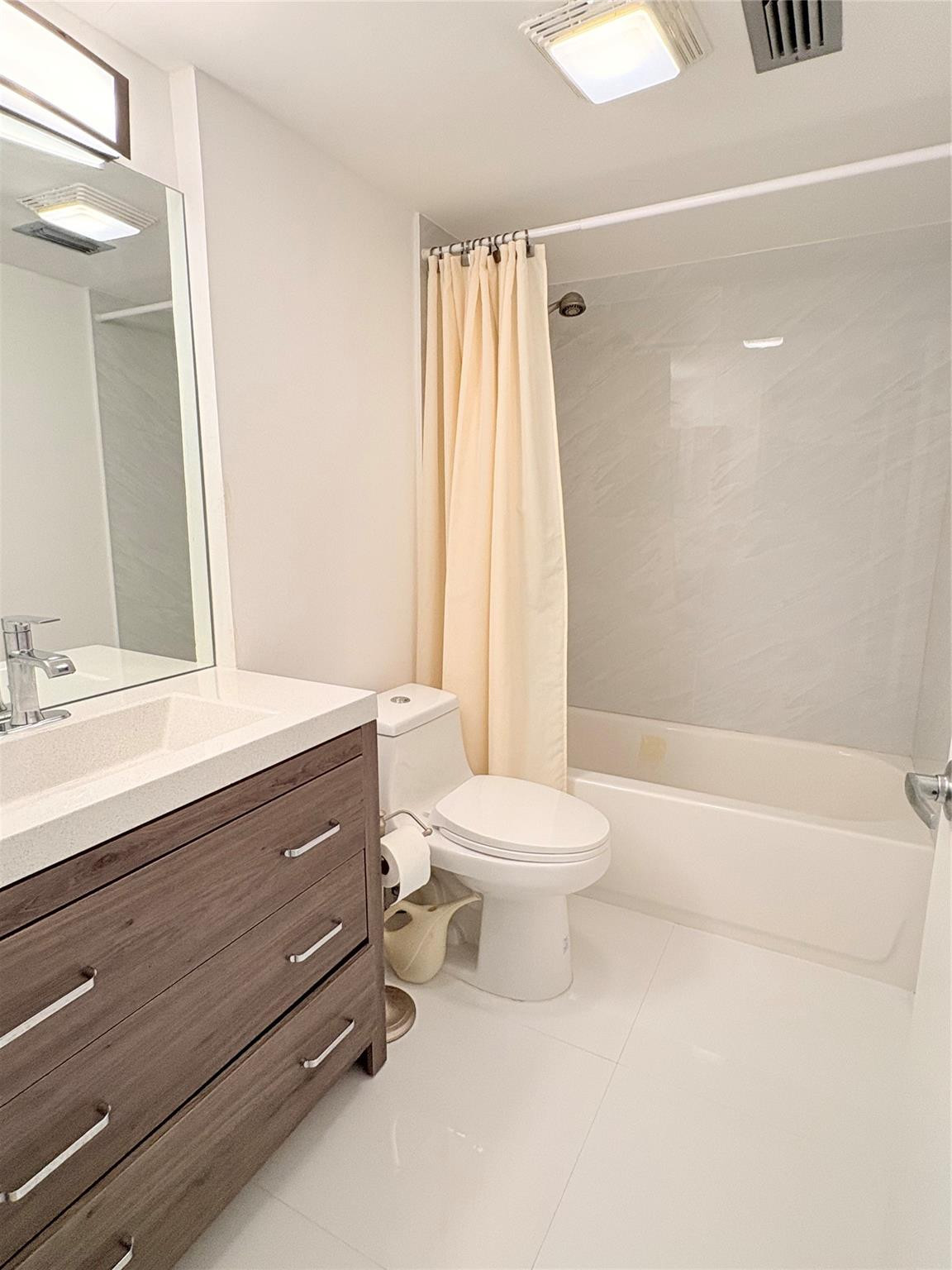 23099 Barwood Lane North, Unit 308 Boca Raton, FL 33428 - Photo 8 of 10 a bathroom with a sink a toilet and shower