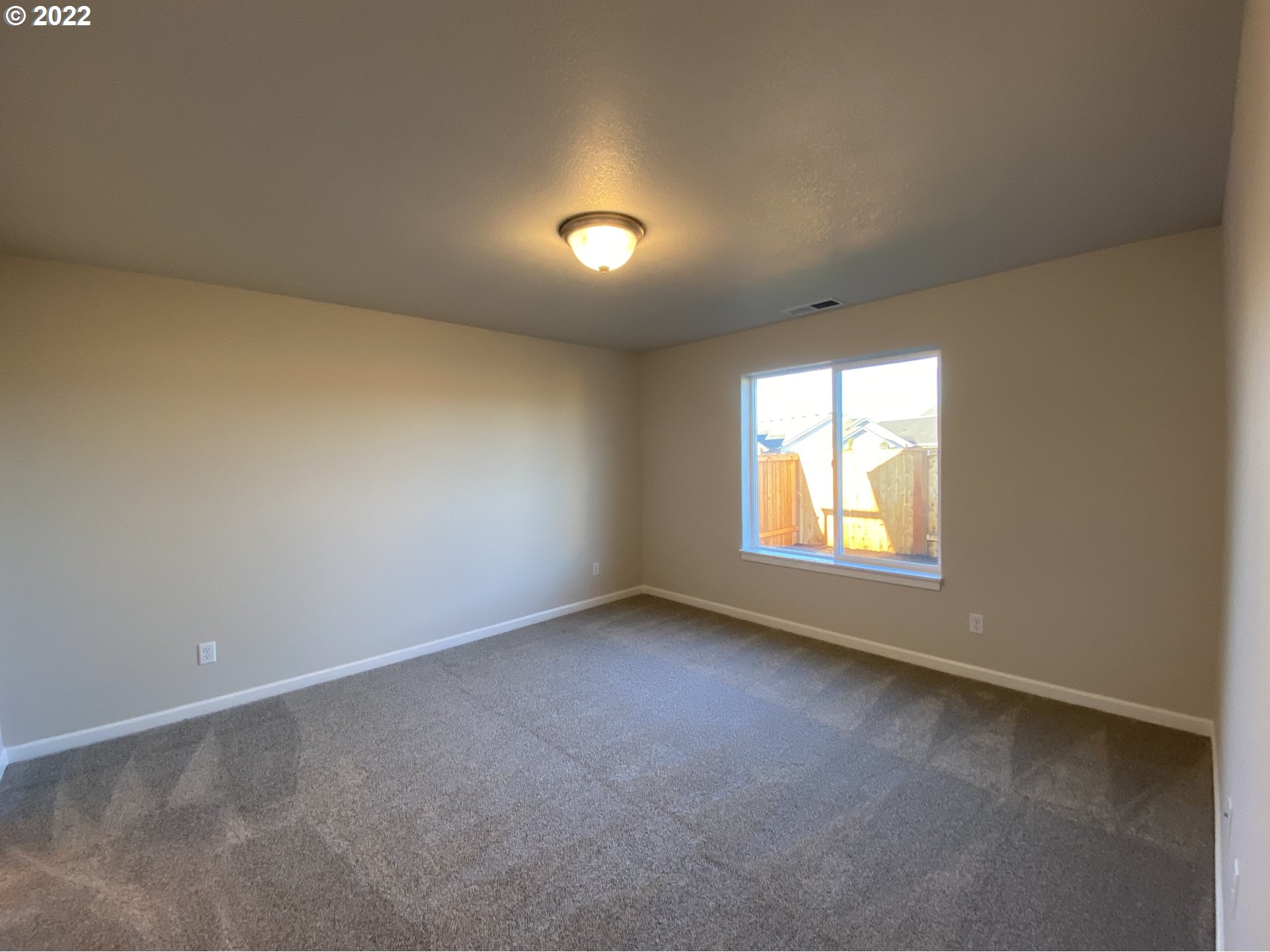413 Southeast Ray Street, Unit 39 Dallas, OR 97338 - Photo 8 of 15 an empty room with a window