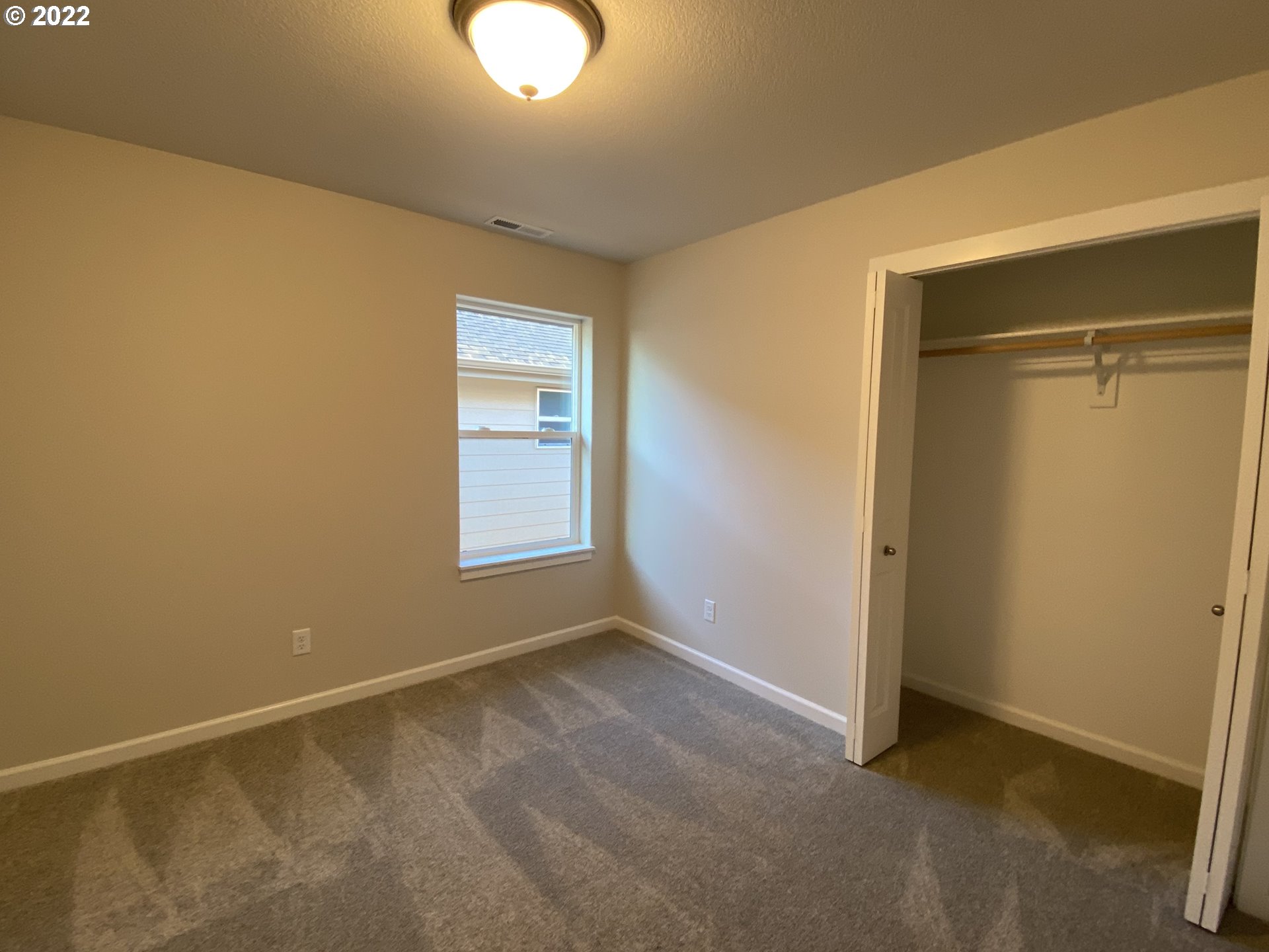 413 Southeast Ray Street, Unit 39 Dallas, OR 97338 - Photo 9 of 15 a view of an empty room with a window
