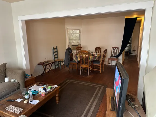 a living room with furniture gym equipment and a rug