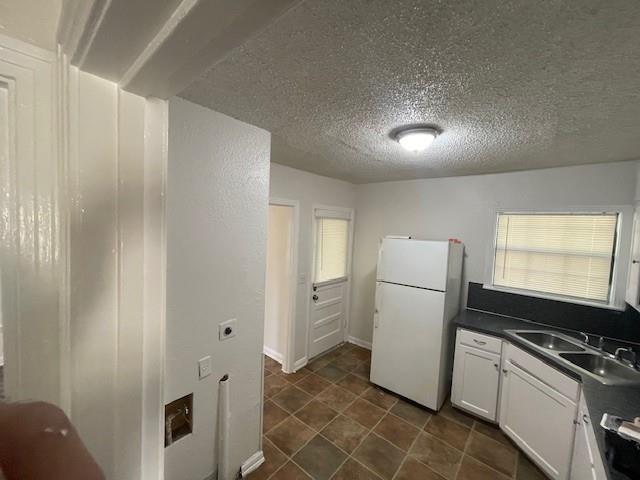 7428 Gaston Avenue Fort Worth, TX 76116 - Photo 11 of 17 a kitchen with a refrigerator and a stove top oven