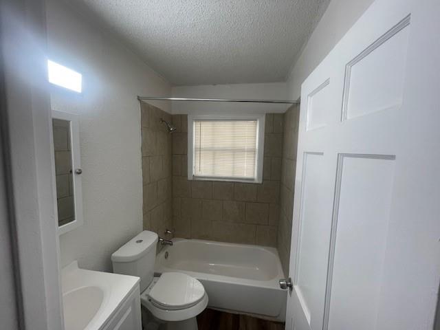 7428 Gaston Avenue Fort Worth, TX 76116 - Photo 13 of 17 a bathroom with a toilet a sink and a bathtub