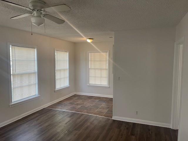 7428 Gaston Avenue Fort Worth, TX 76116 - Photo 7 of 17 an empty room with wooden floor fan and windows