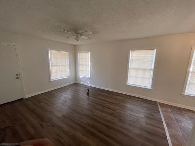7428 Gaston Avenue Fort Worth, TX 76116 - Photo 9 of 17 an empty room with wooden floor and windows