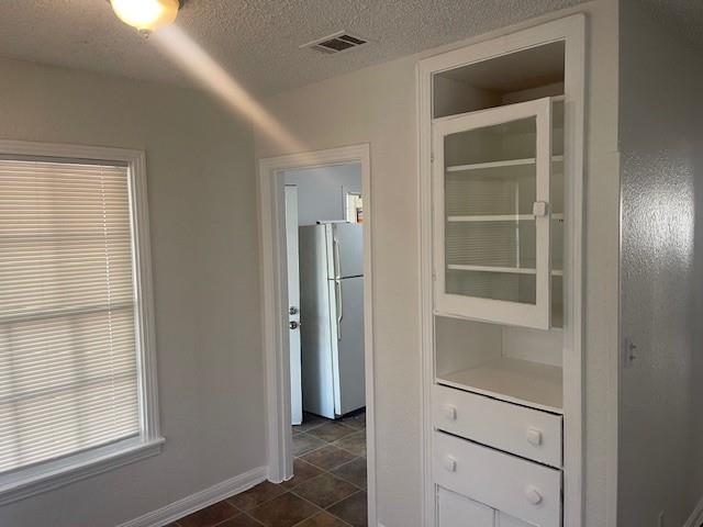 7428 Gaston Avenue Fort Worth, TX 76116 - Photo 10 of 17 a view of walk in closet with empty racks