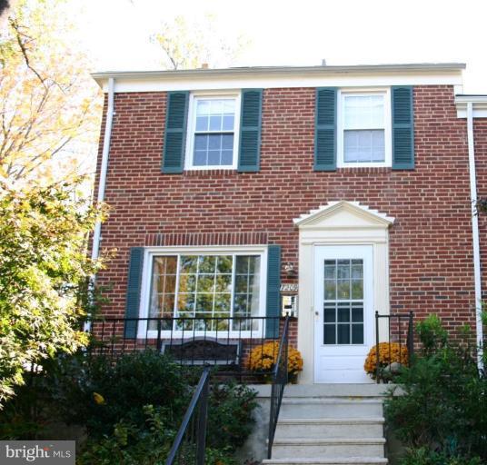 7209 Lanark Road Baltimore, MD 21212 - Photo 1 of 15 a view of a brick house with plants and large tree