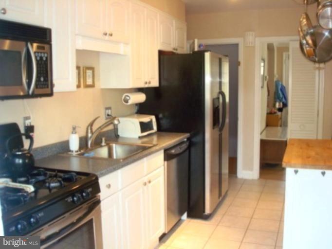 7209 Lanark Road Baltimore, MD 21212 - Photo 13 of 15 a kitchen with stainless steel appliances granite countertop a refrigerator and a stove