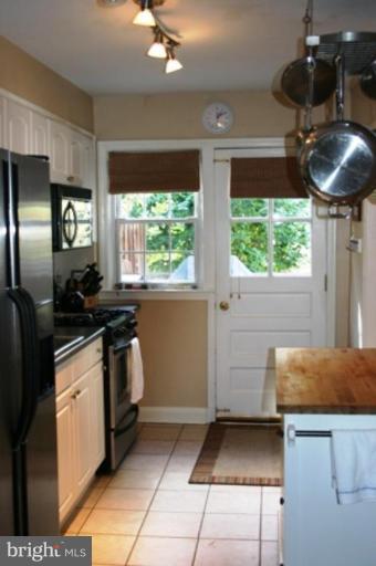 7209 Lanark Road Baltimore, MD 21212 - Photo 3 of 15 a kitchen with stainless steel appliances granite countertop a sink a stove and a refrigerator