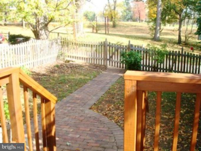 7209 Lanark Road Baltimore, MD 21212 - Photo 7 of 15 a view of a pathway of a park with wooden fence