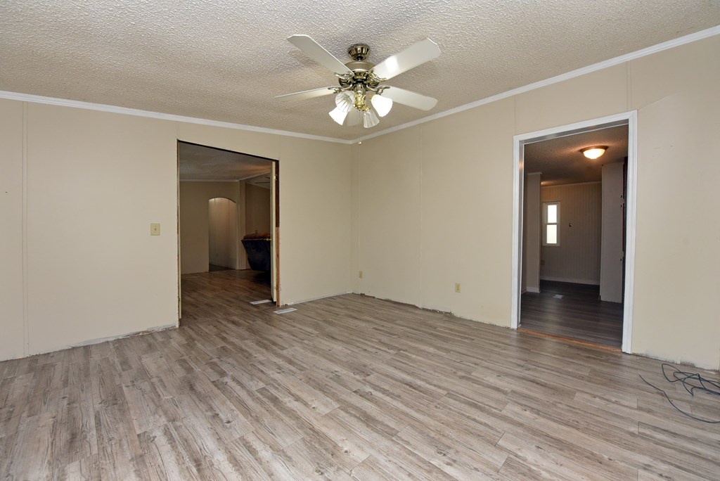 85 Truelove Road Blairsville, GA 30512 - Photo 11 of 35 a view of an empty room with wooden floor and a ceiling fan