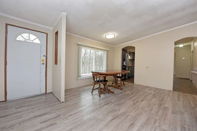 an empty room with wooden floor and a window
