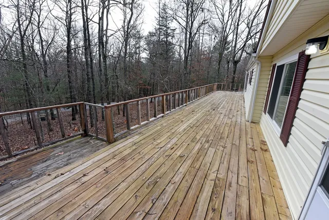 a view of balcony with wooden floor and fence