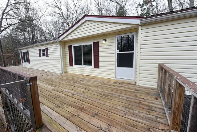 a view of a house with wooden deck