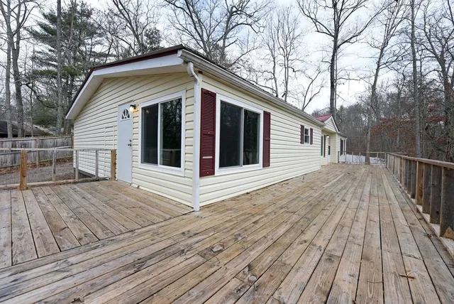 a view of house with wooden floor and fence