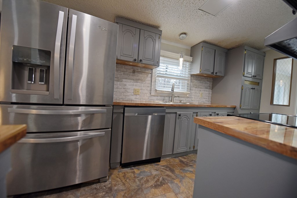 85 Truelove Road Blairsville, GA 30512 - Photo 21 of 35 a kitchen with stainless steel appliances granite countertop a refrigerator a sink and a stove