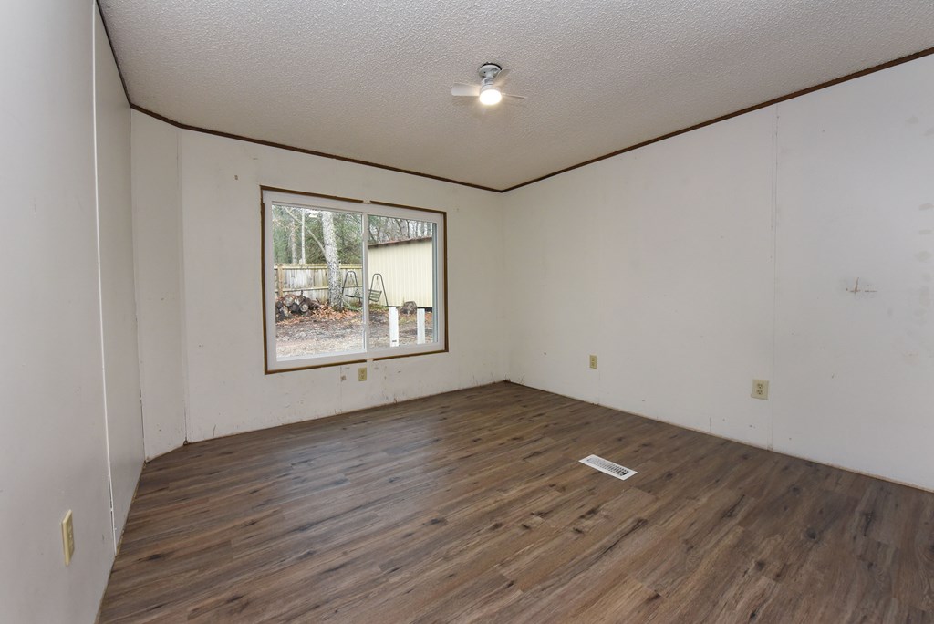 85 Truelove Road Blairsville, GA 30512 - Photo 27 of 35 an empty room with wooden floor and windows