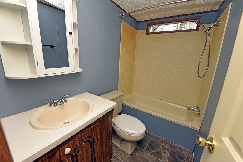 85 Truelove Road Blairsville, GA 30512 - Photo 29 of 35 a bathroom with a sink mirror vanity and toilet