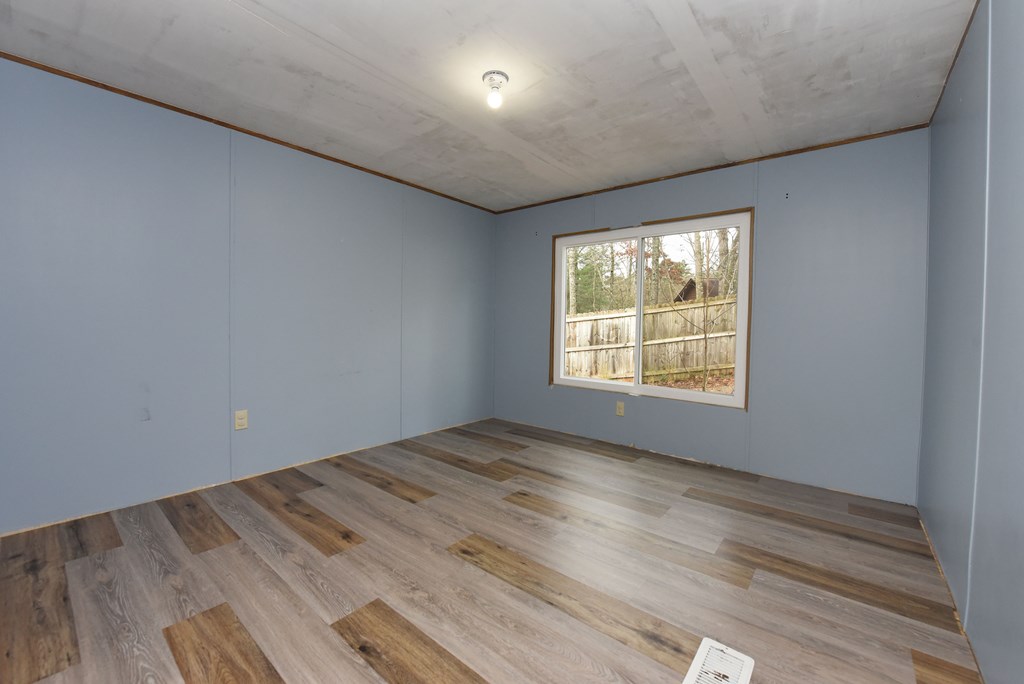 85 Truelove Road Blairsville, GA 30512 - Photo 30 of 35 an empty room with wooden floor and windows