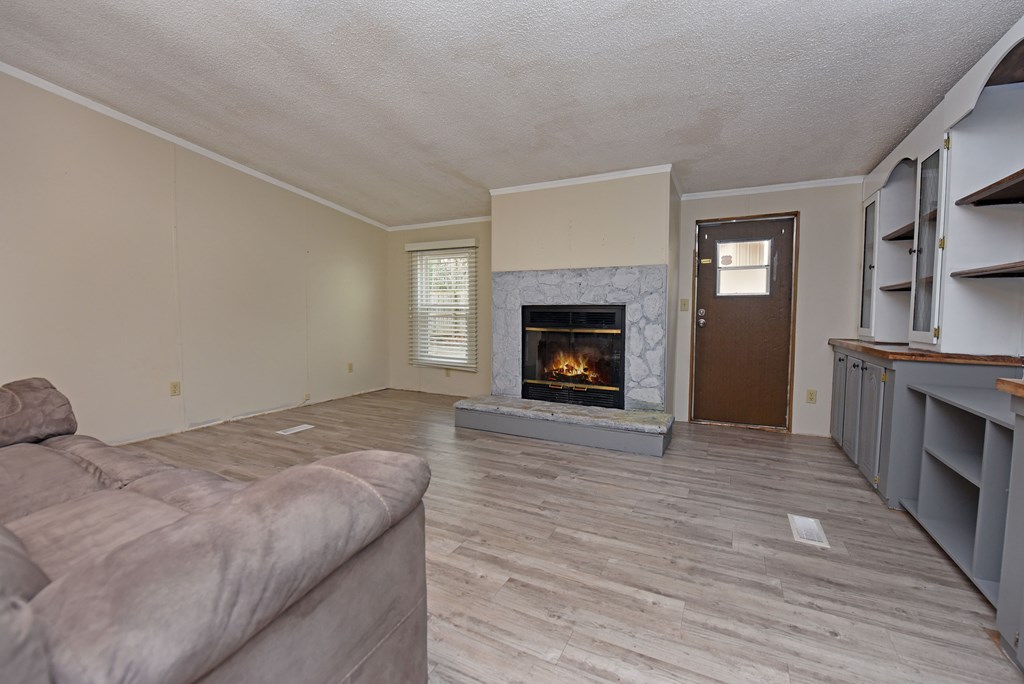 85 Truelove Road Blairsville, GA 30512 - Photo 5 of 35 a bedroom with a bed and a fireplace