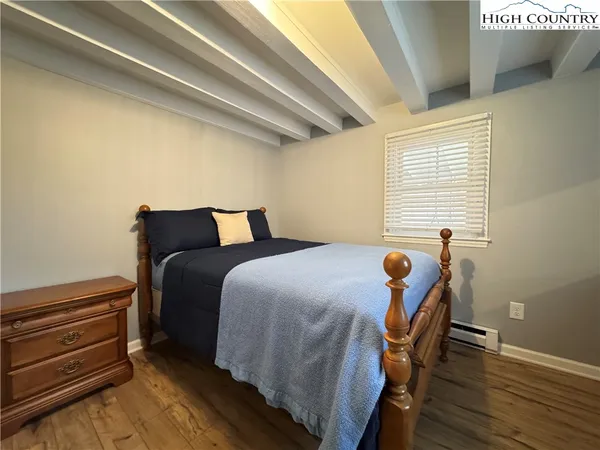 a bedroom with furniture and wooden floor