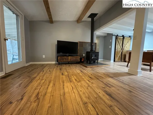 a view of a livingroom with wooden floor and furniture