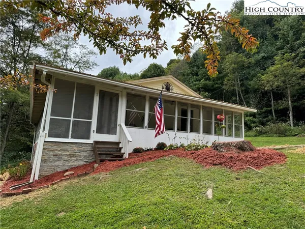 a view of house with backyard
