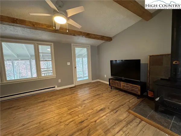 a living room with a flat screen tv and a fireplace