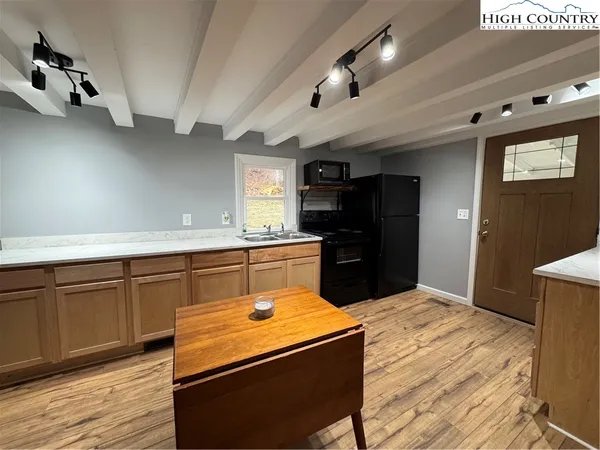 a kitchen with stainless steel appliances granite countertop a sink and wooden cabinets