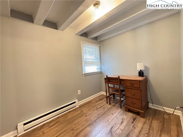 a room with wooden floor and furniture