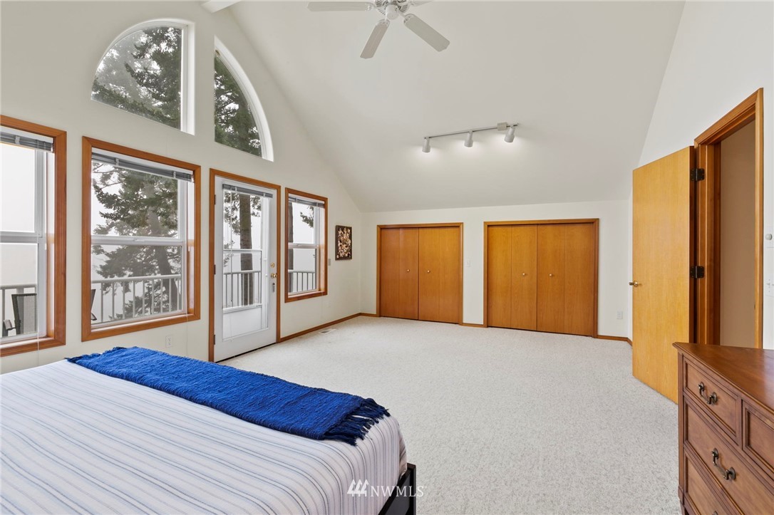 200 East Sund Road Grapeview, WA 98546 - Photo 25 of 40 a bedroom with a large bed and a window