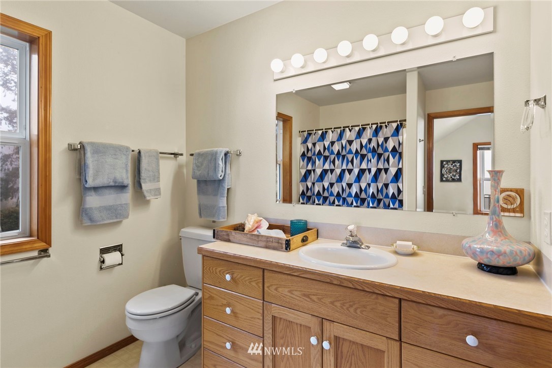 200 East Sund Road Grapeview, WA 98546 - Photo 26 of 40 a bathroom with a sink vanity granite and toilet