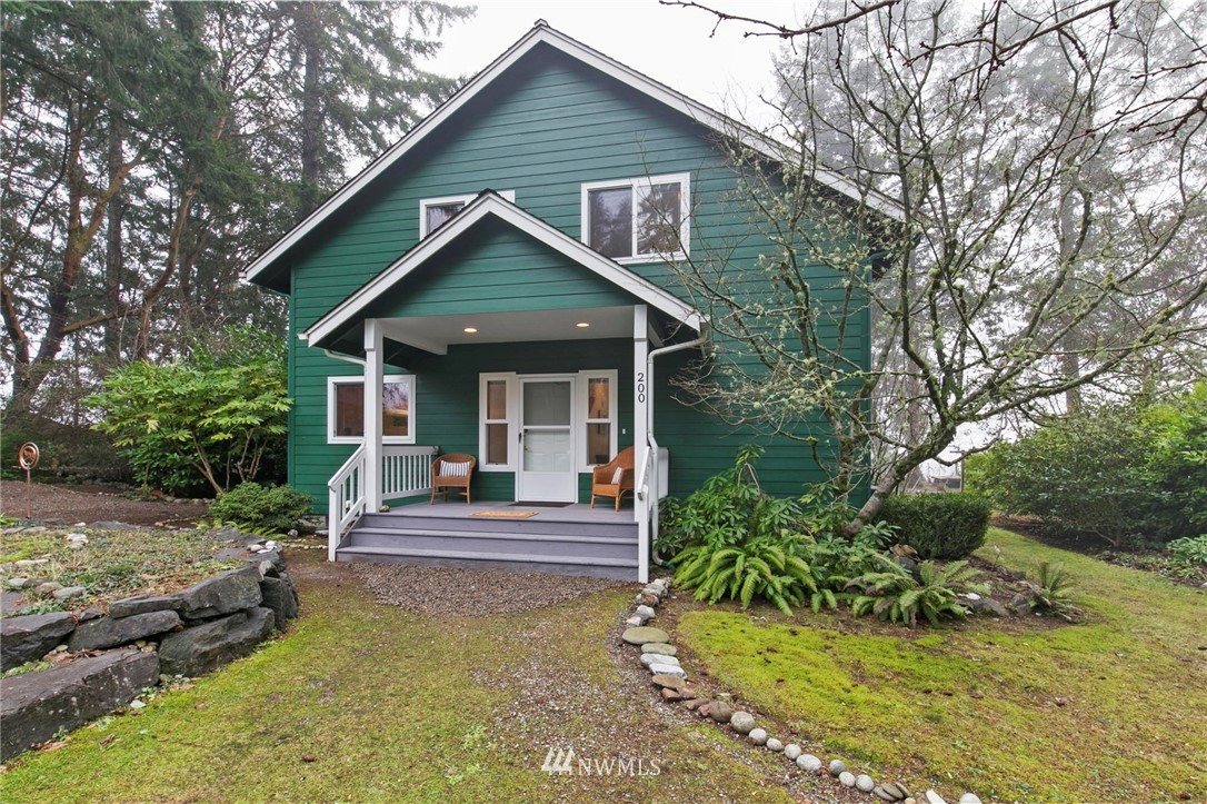 200 East Sund Road Grapeview, WA 98546 - Photo 8 of 40 a front view of a house with a yard table and chairs