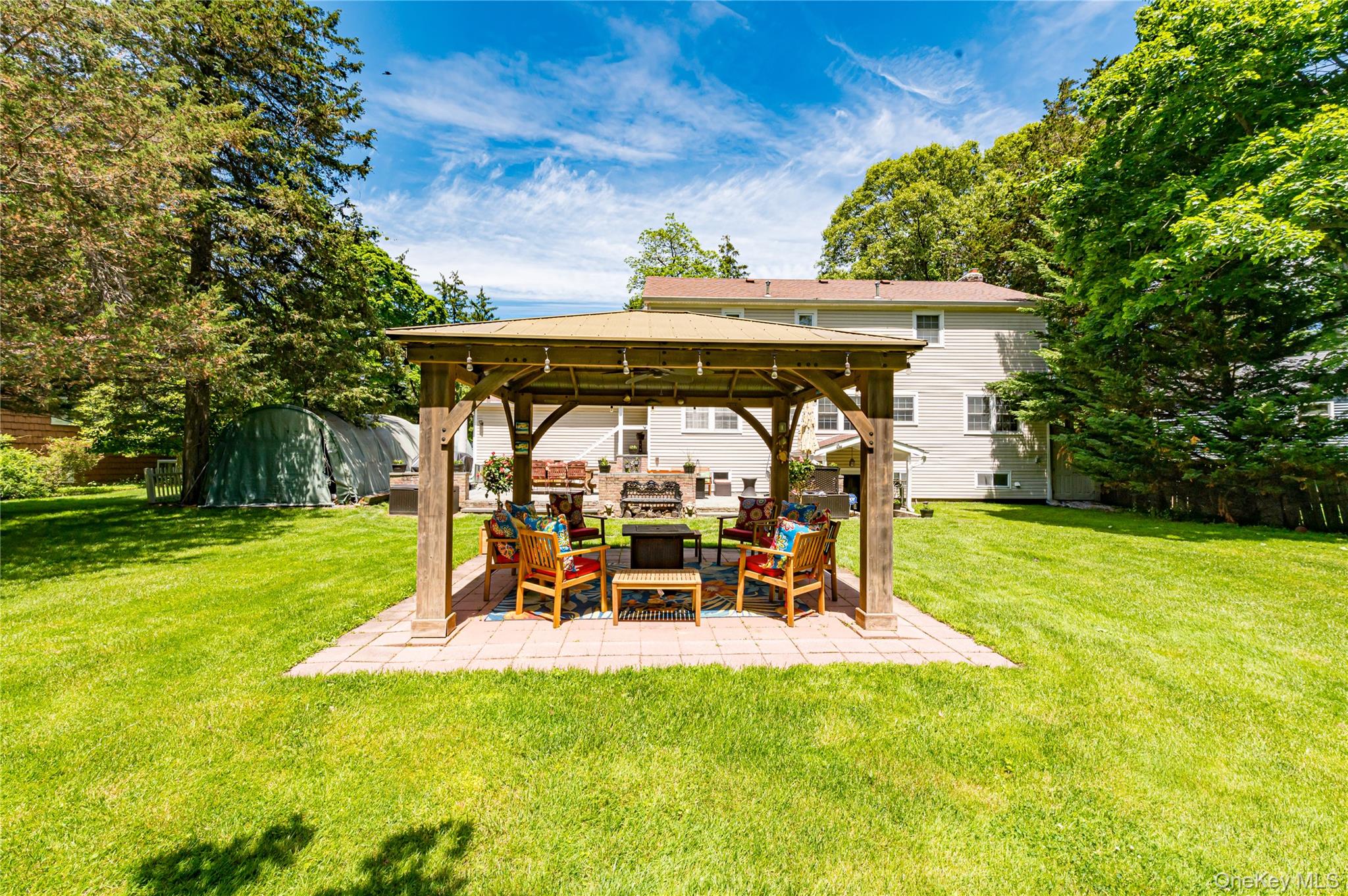 3 Thompson Hill Road St. James, NY 11780 - Photo 32 of 34 a view of a patio with table and chairs potted plants and large tree
