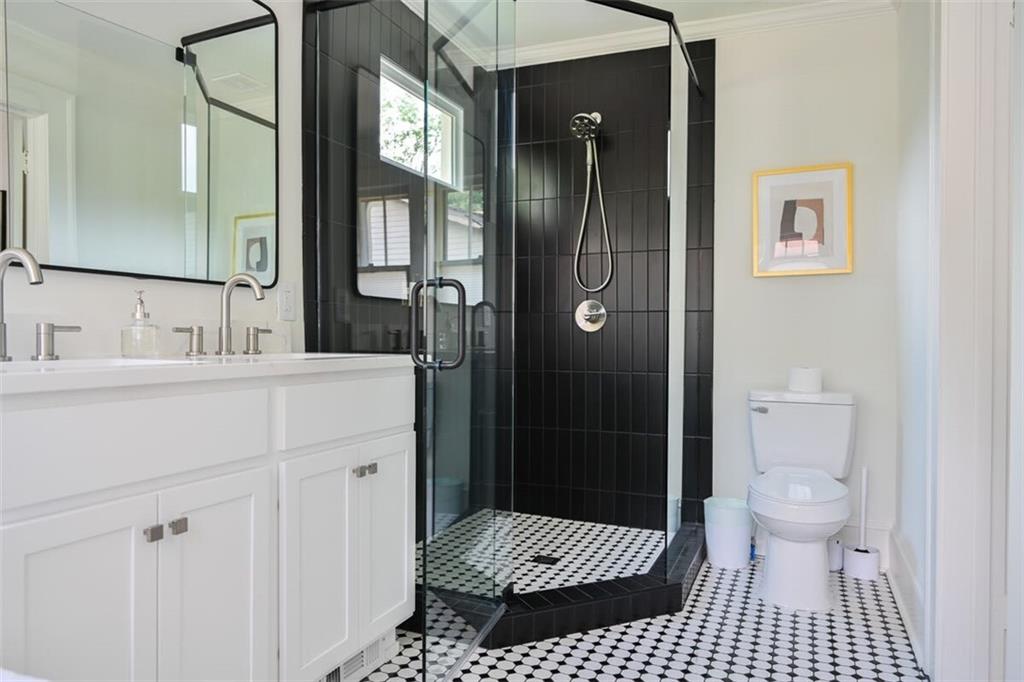1085 Hardee Street Northeast, Unit A Atlanta, GA 30307 - Photo 18 of 32 a bathroom with a sink a toilet a shower and a mirror