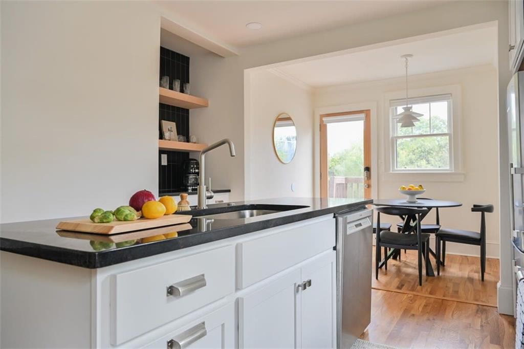 1085 Hardee Street Northeast, Unit A Atlanta, GA 30307 - Photo 21 of 32 a hallway with a table and chairs