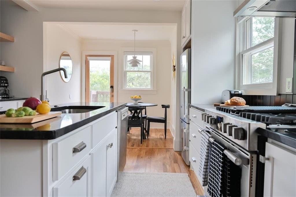 1085 Hardee Street Northeast, Unit A Atlanta, GA 30307 - Photo 22 of 32 a kitchen with stainless steel appliances granite countertop a stove and a sink