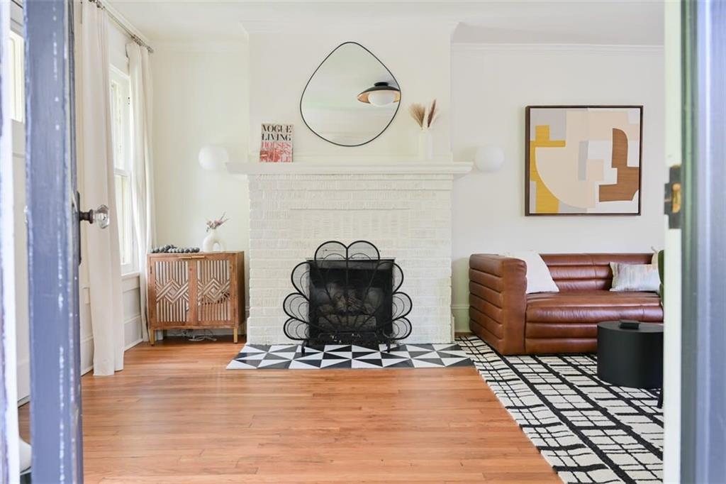 1085 Hardee Street Northeast, Unit A Atlanta, GA 30307 - Photo 24 of 32 a living room with furniture a fireplace and a table