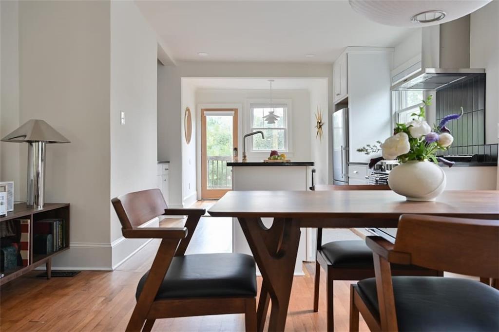 1085 Hardee Street Northeast, Unit A Atlanta, GA 30307 - Photo 4 of 32 a view of a dining room with furniture and wooden floor