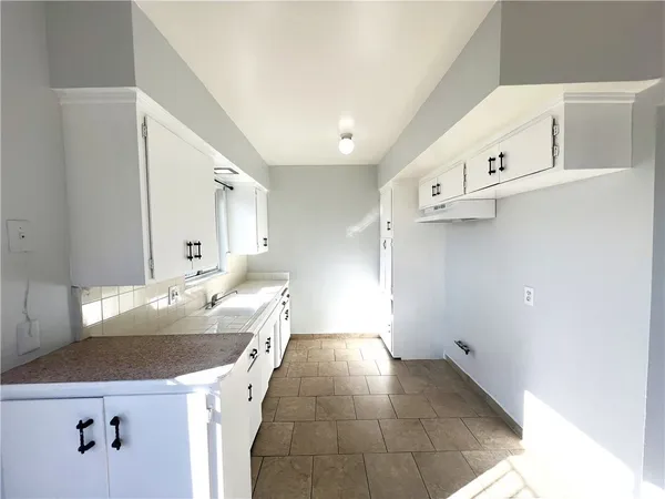 a kitchen with a sink and a stove top oven