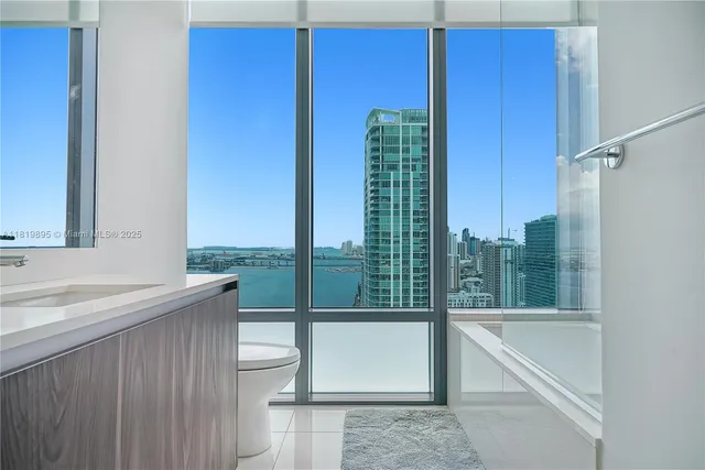 a view of a kitchen with a sink and refrigerator