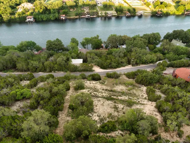 an aerial view of a houses with a lake view