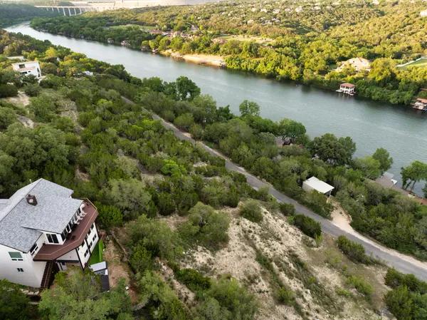 an aerial view of a house with a garden and lake view