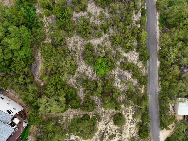 an aerial view of a houses with yard