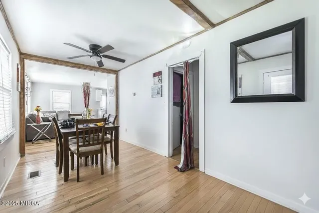 a view of a dining room with furniture and wooden floor