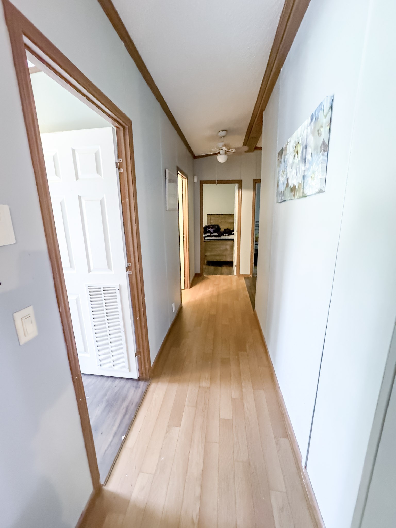 189 Pioneer Road Hohenwald, TN 38462 - Photo 12 of 20 a view of a hallway with wooden floor and staircase