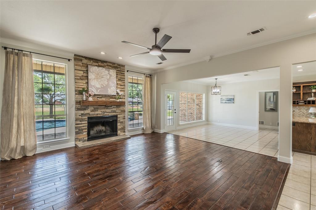13507 Friendship Road Pilot Point, TX 76258 - Photo 3 of 39 wooden floor fireplace and windows in an empty room